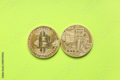 Golden bitcoins on green ba...