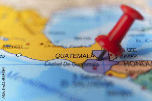 Obraz na płótnie Red push pin locating guatemala on a physical map, highlighting central america