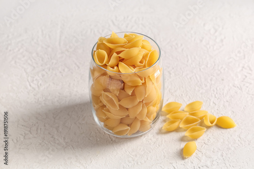 Glass with raw pasta shells...