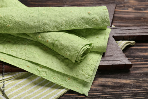 Board with green lavash on ...