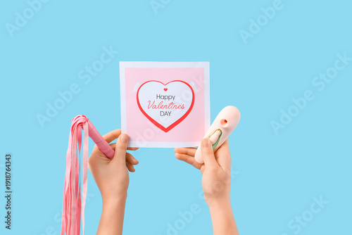 Woman holding sex toys with...