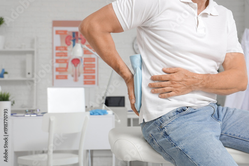 Mature man putting hot wate...