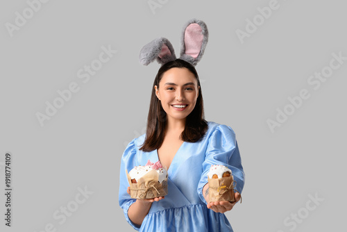 Smiling young woman in bunn...