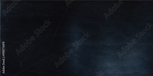 A blank black chalkboard with chalk rests on a dark grunge texture wall featuring an old vintage rough surface backdrop
