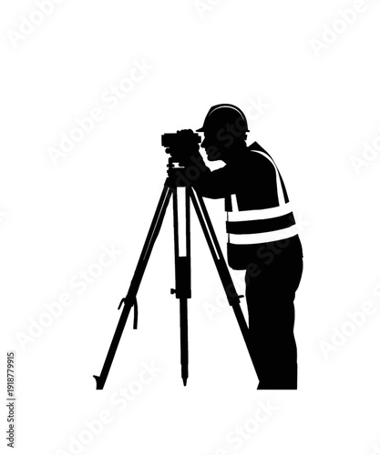 Professional photographer in safety vest adjusting tripod camera outdoors black and white