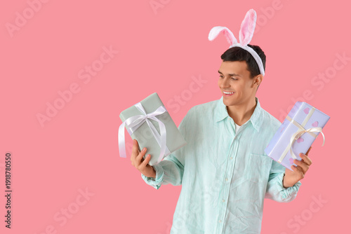 Happy young man in bunny ea...
