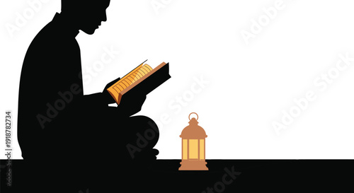 Silhouette of man reading holy book beside a glowing lantern.