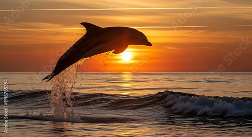 Silhouette of a joyful dolphin leaping high above the ocean waves against a dramatic and vibrant golden orange sunset backdrop creating a stunning natural wildlife moment.