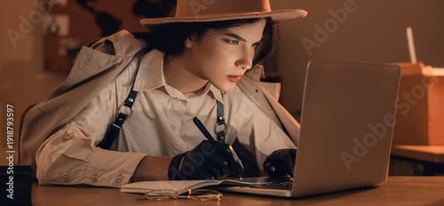 Fotografi Female spy with laptop writing on notebook in office at night