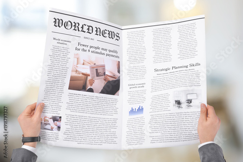 Canvas-taulu Young businessman reading newspaper on white background