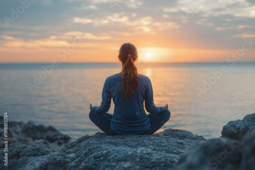 Serene Woman Meditating on a Coastal Rock During a Breathtaking Sunset, Embracing Mindfulness, Inner Peace, and Wellness by the Tranquil Ocean.