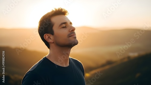 Peaceful Man Breathing Fresh Air at Sunset in the Mountains