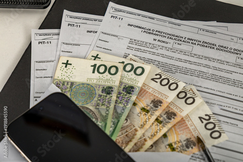 Photos PIT-11 polish tax form on accountant table with pen close up