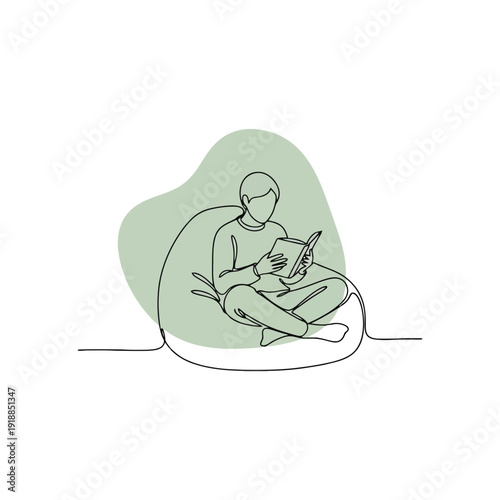 Person Sitting on Bean Bag Chair with Laptop.