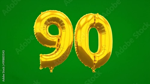 Celebrating a milestone birthday with golden inflatable balloons against a vibrant green background
