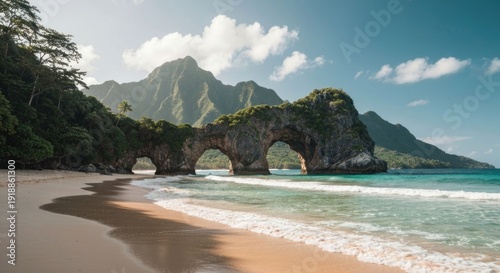 Arched rock on beach with lush mountain backdrop