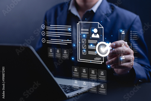 Businessman reviewing digital resume and candidate profile on laptop with approval check mark, representing recruitment process, HR management, job application screening, talent acquisition concept.