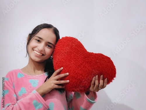 asian girl posing with a laptop, with a heart plushy for Valentine's Day, with a smartphone doing poses like happy, smile, angry and excited, acting as Gen Z and working lady and working from home
