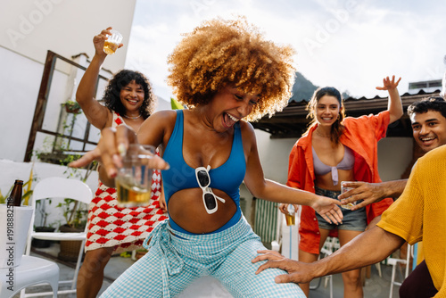 Group of friends dancing outdoors during a lively summer gathering in Rio de Janeiro