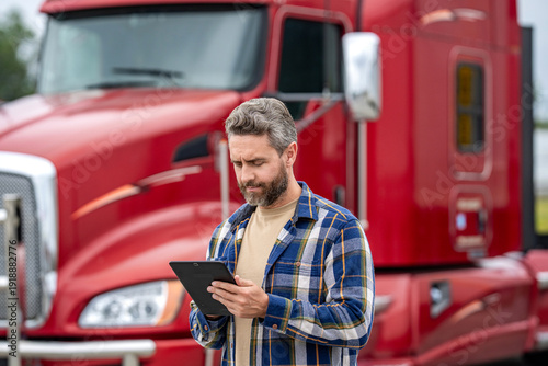 Man owner truck driver. Transportation logistic. Delivery app. Logistics software. Man driver use tablet at lorry truck. Tracking delivery. Truck driver. Trucking owner planning route
