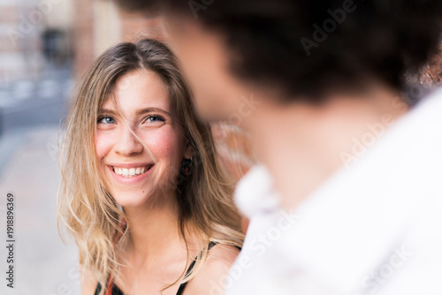 Happy young woman in love looking at boyfriend