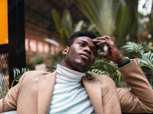 Man sitting with head in hands at station