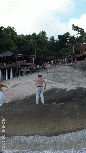 vertical, people dancing on the rocks on Koh Phangan