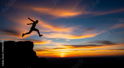 Wallpaper Mural Silhouette of a person jumping from a cliff against a vibrant sunset, representing freedom, courage, and aspiration in the face of challenge Torontodigital.ca