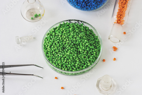 Plastic granules in various colors at an industrial workspace for polymer processing