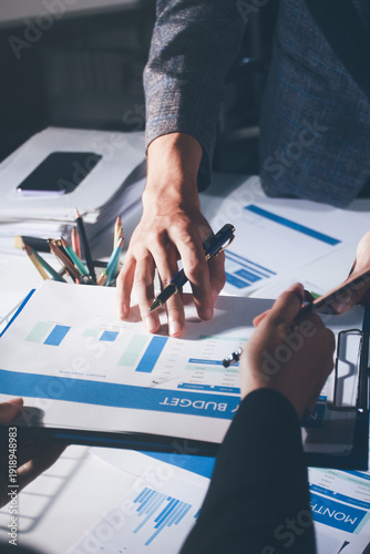 Professional photo of a person's hands reviewing a contract or legal document on a desk, for concepts of business, finance, and legal affairs