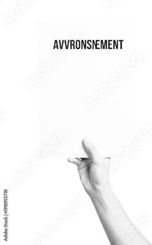 A hand holding a sign with a French word for awakening or uprising.