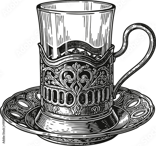 Ornate vintage glass cup with decorative metal holder and matching saucer in black and white