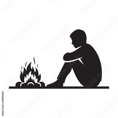 Lonely man sitting by campfire in contemplative mood