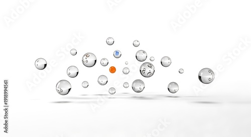 Clear water droplets with one orange and one blue sphere float above a white surface.
