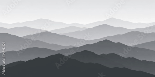 A misty mountain landscape at sunrise features blue forest silhouettes and peaks shrouded in thick fog and morning clouds over a scenic valley