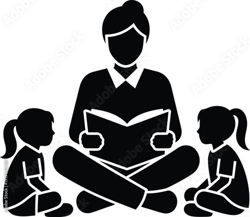 Silhouette Teacher reading storybook to two attentive children sitting crosslegged