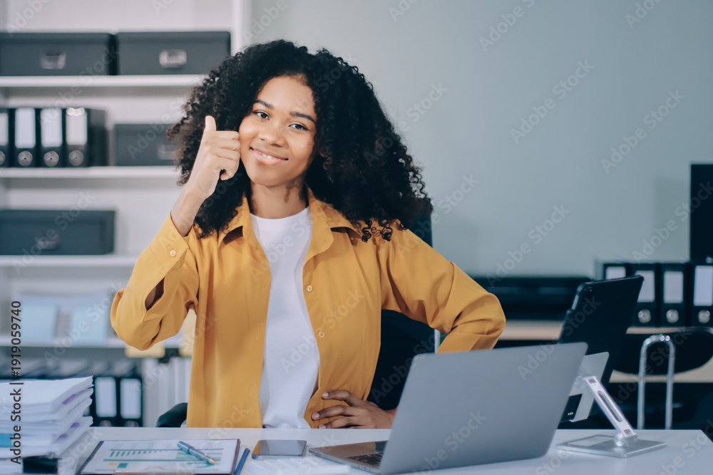 Obraz premium Pretty female freelancer working on laptop while sitting on modern coworking background