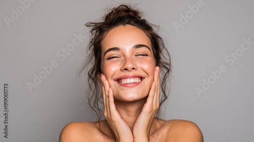 Young woman smiling, touching face, glowing skin, copy space
