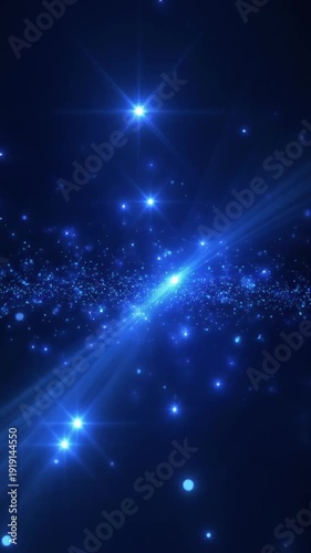 A bright blue light beam shining through a starry night sky with sparkling particles and rays