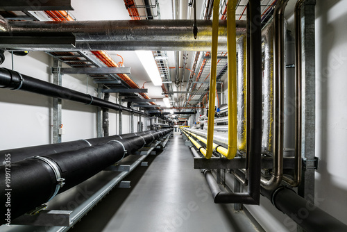Industrial utility corridor with exposed pipelines and cable infrastructure