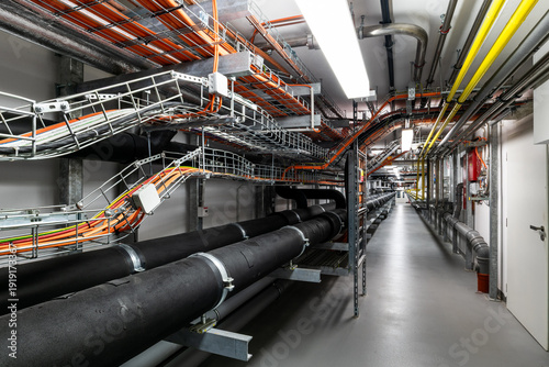 Industrial utility corridor with exposed pipelines and cable infrastructure
