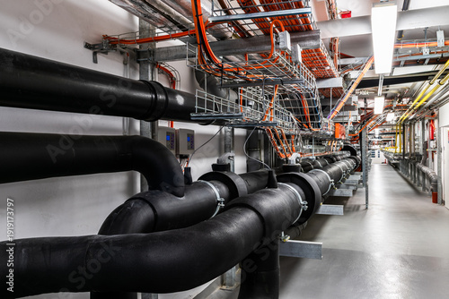 Industrial mechanical room with insulated pipelines and utility systems