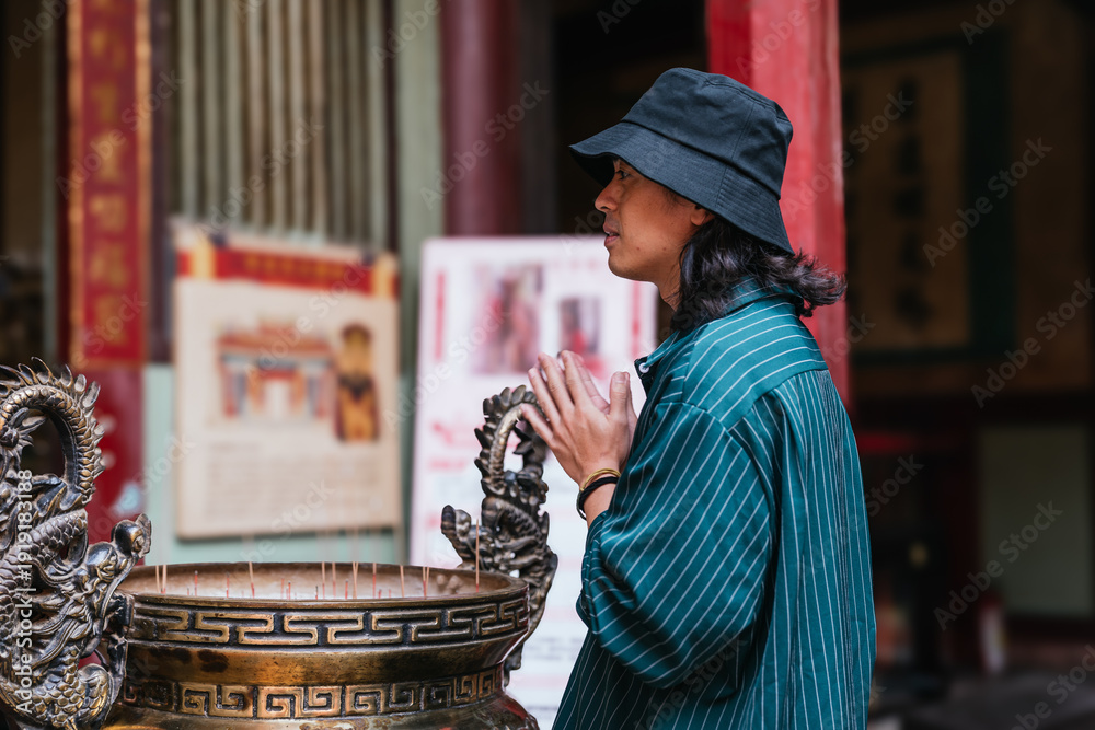 Φωτογραφία Man praying with folded hands at a temple