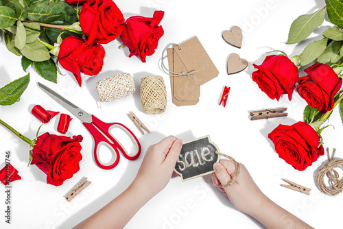 Gift design concept. The child is holding a sign with the inscription Sale in her hands