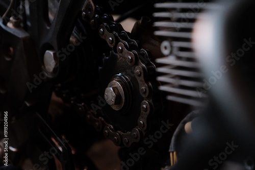 Close up of a motorcycles front sprocket and other components