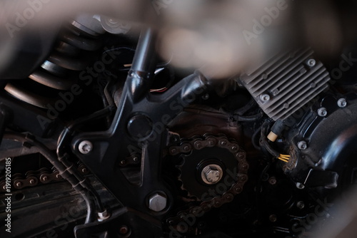 Close up of a motorcycles front sprocket and other components