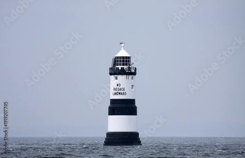 Black and white lighthouse on sea