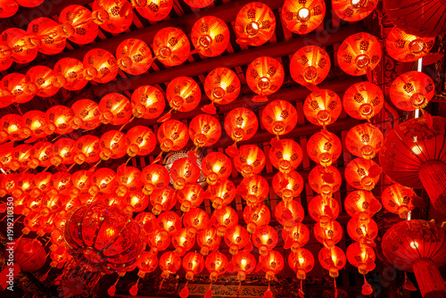Many red lanterns are hung from the ceiling during the Chinese New Year festival in the shrine.