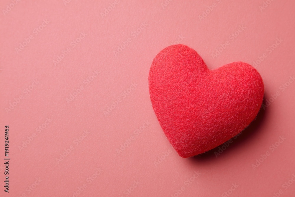 Fototapeta premium Red plush heart on soft pink background