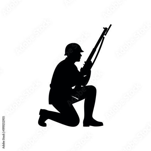 Silhouette of a soldier kneeling with a rifle.